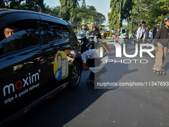 Skaters are taking part in the international world skateboarding day 'Go Skateboarding Day' with a ride around city streets in Malang City,...