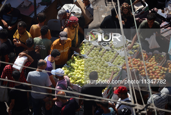 A Palestinian is displaying his wares in a market in Deir al-Balah in the central Gaza Strip, on June 21, 2024, as the conflict is continuin...