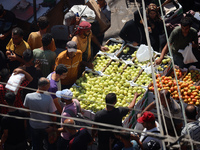 A Palestinian is displaying his wares in a market in Deir al-Balah in the central Gaza Strip, on June 21, 2024, as the conflict is continuin...