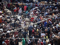 People are walking in a market in Deir al-Balah in the central Gaza Strip, on June 21, 2024, as the conflict in the Palestinian territory be...