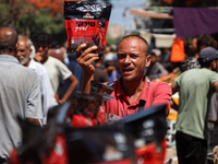 A Palestinian is displaying his wares in a market in Deir al-Balah in the central Gaza Strip, on June 21, 2024, as the conflict is continuin...