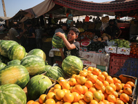 A Palestinian is displaying his wares in a market in Deir al-Balah in the central Gaza Strip, on June 21, 2024, as the conflict is continuin...