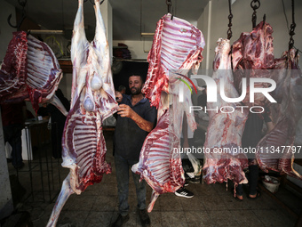 A Palestinian is displaying his wares in a market in Deir al-Balah in the central Gaza Strip, on June 21, 2024, as the conflict is continuin...