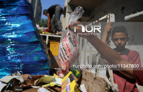 A Palestinian is displaying his wares in a market in Deir al-Balah in the central Gaza Strip, on June 21, 2024, as the conflict is continuin...