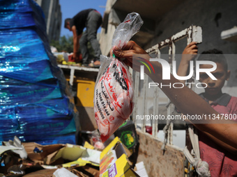 A Palestinian is displaying his wares in a market in Deir al-Balah in the central Gaza Strip, on June 21, 2024, as the conflict is continuin...