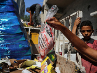 A Palestinian is displaying his wares in a market in Deir al-Balah in the central Gaza Strip, on June 21, 2024, as the conflict is continuin...