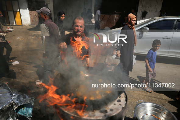 A Palestinian is displaying his wares in a market in Deir al-Balah in the central Gaza Strip, on June 21, 2024, as the conflict is continuin...