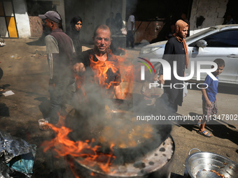 A Palestinian is displaying his wares in a market in Deir al-Balah in the central Gaza Strip, on June 21, 2024, as the conflict is continuin...