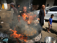 A Palestinian is displaying his wares in a market in Deir al-Balah in the central Gaza Strip, on June 21, 2024, as the conflict is continuin...