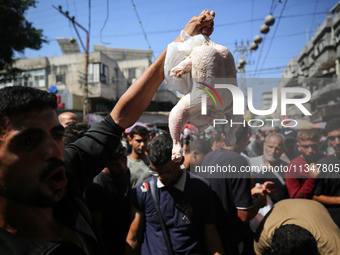 A Palestinian is displaying his wares in a market in Deir al-Balah in the central Gaza Strip, on June 21, 2024, as the conflict is continuin...