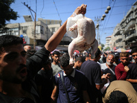 A Palestinian is displaying his wares in a market in Deir al-Balah in the central Gaza Strip, on June 21, 2024, as the conflict is continuin...