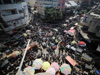 People are walking in a market in Deir al-Balah in the central Gaza Strip, on June 21, 2024, as the conflict in the Palestinian territory be...