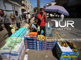 A Palestinian is displaying his wares in a market in Deir al-Balah in the central Gaza Strip, on June 21, 2024, as the conflict is continuin...