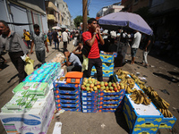 A Palestinian is displaying his wares in a market in Deir al-Balah in the central Gaza Strip, on June 21, 2024, as the conflict is continuin...