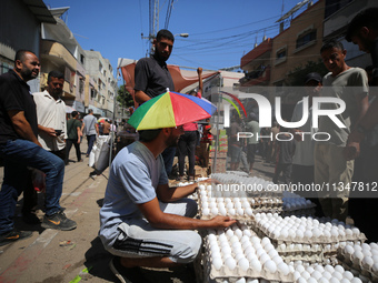 A Palestinian is displaying his wares in a market in Deir al-Balah in the central Gaza Strip, on June 21, 2024, as the conflict is continuin...