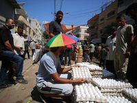 A Palestinian is displaying his wares in a market in Deir al-Balah in the central Gaza Strip, on June 21, 2024, as the conflict is continuin...