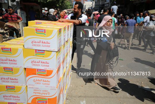 A Palestinian is displaying his wares in a market in Deir al-Balah in the central Gaza Strip, on June 21, 2024, as the conflict is continuin...