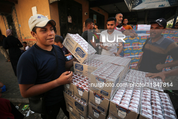 A Palestinian is displaying his wares in a market in Deir al-Balah in the central Gaza Strip, on June 21, 2024, as the conflict is continuin...