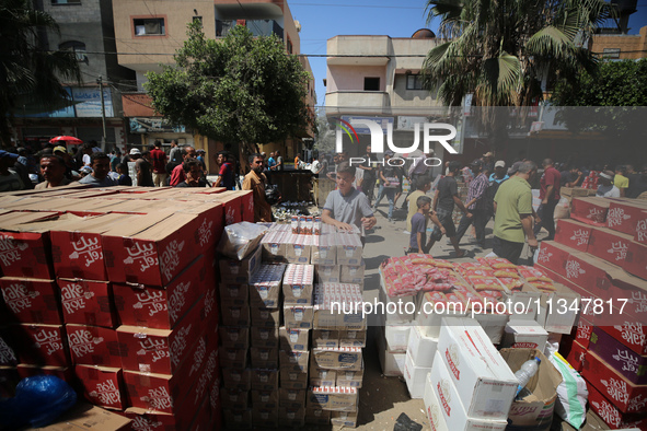 A Palestinian is displaying his wares in a market in Deir al-Balah in the central Gaza Strip, on June 21, 2024, as the conflict is continuin...