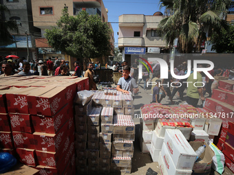 A Palestinian is displaying his wares in a market in Deir al-Balah in the central Gaza Strip, on June 21, 2024, as the conflict is continuin...