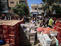 A Palestinian is displaying his wares in a market in Deir al-Balah in the central Gaza Strip, on June 21, 2024, as the conflict is continuin...