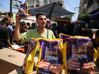 A Palestinian is displaying his wares in a market in Deir al-Balah in the central Gaza Strip, on June 21, 2024, as the conflict is continuin...