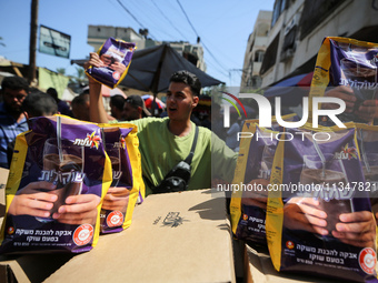 A Palestinian is displaying his wares in a market in Deir al-Balah in the central Gaza Strip, on June 21, 2024, as the conflict is continuin...