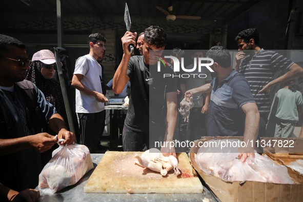 A Palestinian is displaying his wares in a market in Deir al-Balah in the central Gaza Strip, on June 21, 2024, as the conflict is continuin...