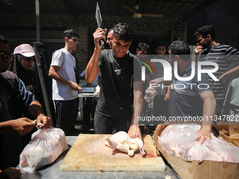 A Palestinian is displaying his wares in a market in Deir al-Balah in the central Gaza Strip, on June 21, 2024, as the conflict is continuin...