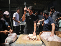 A Palestinian is displaying his wares in a market in Deir al-Balah in the central Gaza Strip, on June 21, 2024, as the conflict is continuin...