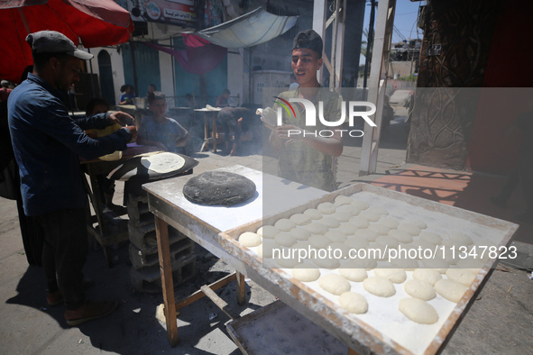 A Palestinian is displaying his wares in a market in Deir al-Balah in the central Gaza Strip, on June 21, 2024, as the conflict is continuin...