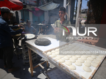 A Palestinian is displaying his wares in a market in Deir al-Balah in the central Gaza Strip, on June 21, 2024, as the conflict is continuin...