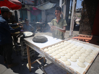 A Palestinian is displaying his wares in a market in Deir al-Balah in the central Gaza Strip, on June 21, 2024, as the conflict is continuin...