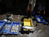 A Palestinian is displaying his wares in a market in Deir al-Balah in the central Gaza Strip, on June 21, 2024, as the conflict is continuin...