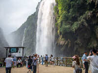 Tourists are viewing a waterfall at the Maling River Canyon scenic spot in Xingyi, China, on June 21, 2024. (