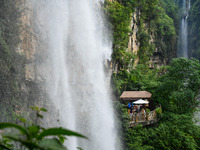 Tourists are viewing a waterfall at the Maling River Canyon scenic spot in Xingyi, China, on June 21, 2024. (