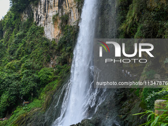 Tourists are viewing a waterfall at the Maling River Canyon scenic spot in Xingyi, China, on June 21, 2024. (