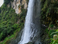 Tourists are viewing a waterfall at the Maling River Canyon scenic spot in Xingyi, China, on June 21, 2024. (