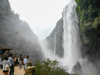 Tourists are viewing a waterfall at the Maling River Canyon scenic spot in Xingyi, China, on June 21, 2024. (