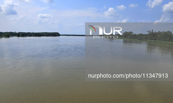 The river water of Teesta is flowing with an increased water level due to heavy rainfall in Jalpaiguri, Sikkim, on June 21, 2024, some 75 km...