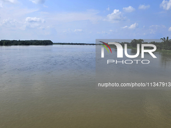 The river water of Teesta is flowing with an increased water level due to heavy rainfall in Jalpaiguri, Sikkim, on June 21, 2024, some 75 km...