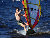 A man is practicing windsurfing on the Kremenchuk Reservoir in Cherkasy, Ukraine, on June 20, 2024. NO USE RUSSIA. NO USE BELARUS. (