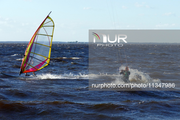 People are practicing kiteboarding and windsurfing on the Kremenchuk Reservoir in Cherkasy, Ukraine, on June 20, 2024. NO USE RUSSIA. NO USE...