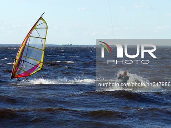 People are practicing kiteboarding and windsurfing on the Kremenchuk Reservoir in Cherkasy, Ukraine, on June 20, 2024. NO USE RUSSIA. NO USE...