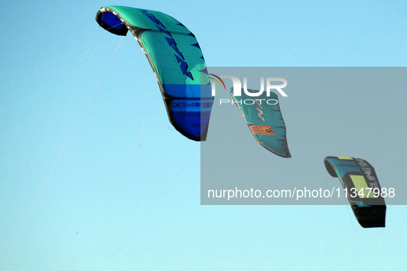 Three power kites are flying in the sky in Cherkasy, Ukraine, on June 20, 2024. 