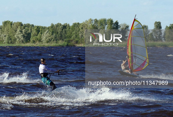 People are practicing kiteboarding and windsurfing on the Kremenchuk Reservoir in Cherkasy, Ukraine, on June 20, 2024. NO USE RUSSIA. NO USE...