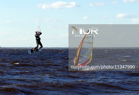 People are practicing kiteboarding and windsurfing on the Kremenchuk Reservoir in Cherkasy, Ukraine, on June 20, 2024. NO USE RUSSIA. NO USE...