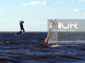 People are practicing kiteboarding and windsurfing on the Kremenchuk Reservoir in Cherkasy, Ukraine, on June 20, 2024. NO USE RUSSIA. NO USE...