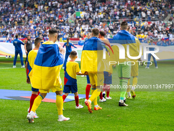 The players of Ukraine are walking onto the pitch  during the UEFA EURO 2024 group stage match between Slovakia and Ukraine at Düsseldorf Ar...