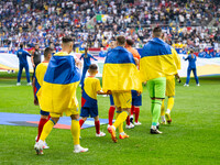 The players of Ukraine are walking onto the pitch  during the UEFA EURO 2024 group stage match between Slovakia and Ukraine at Düsseldorf Ar...